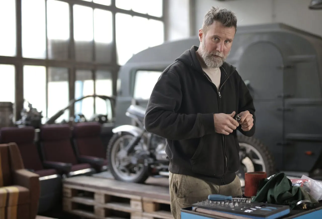 A mechanic handing a customer the repair invoice