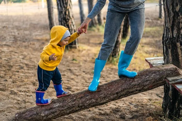 Childcare and education invoice templates: a parent walking a toddler along a log