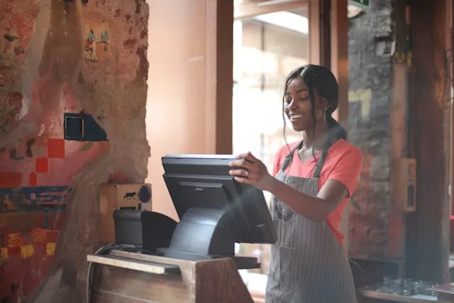 Food and hospitality invoice templates: a smiling cashier at a café counter
