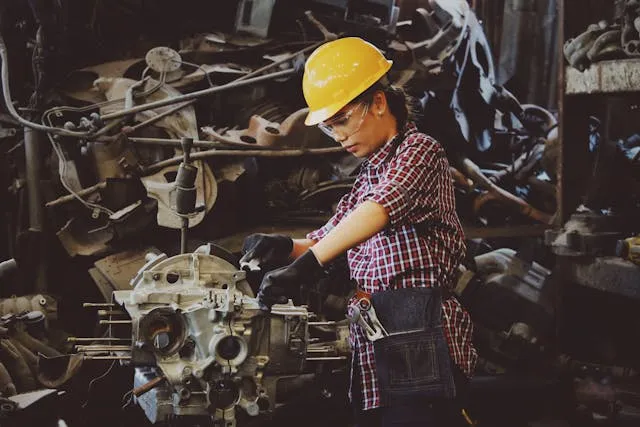 Manufacturing and supply chain invoice templates: an engineer in a hard hat at a machine