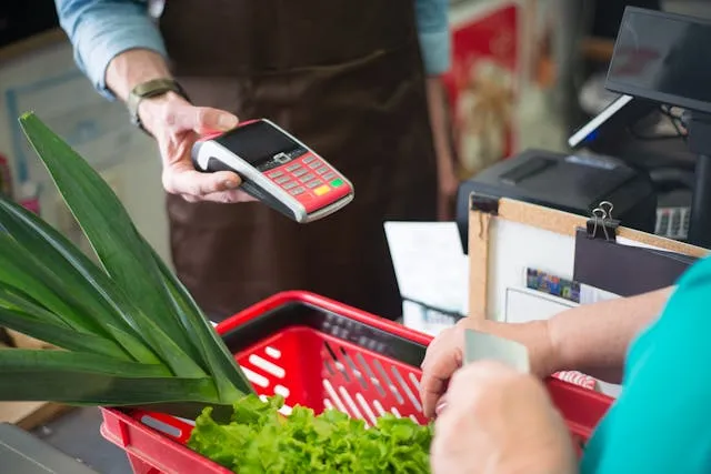 Retail and sales invoice templates: a customer paying by card at a checkout
